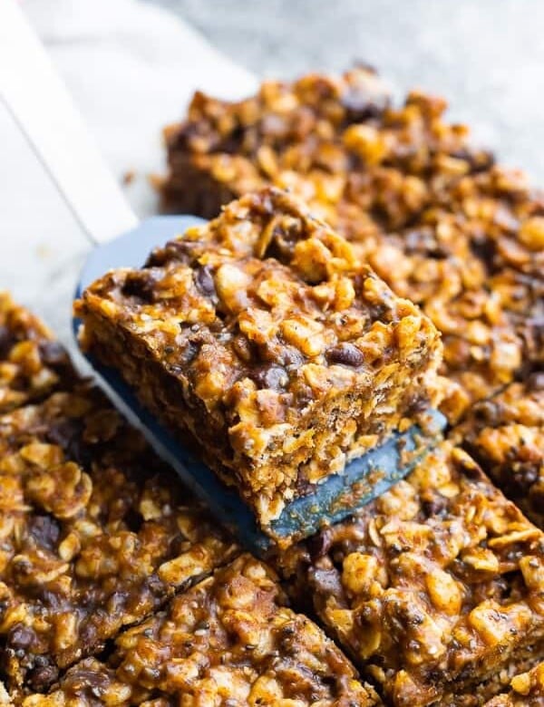 a spatula picking of a slice of no bake snack bars