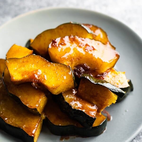 pile of maple butter roasted acorn squash on gray plate