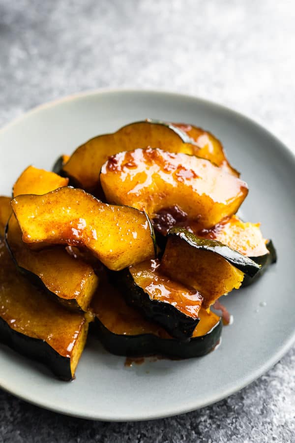 pile of maple butter roasted acorn squash on gray plate