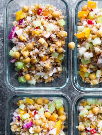overhead shot of four glass meal prep container with chopped chickpea salad