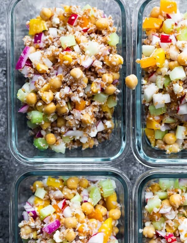 overhead shot of four glass meal prep container with chopped chickpea salad