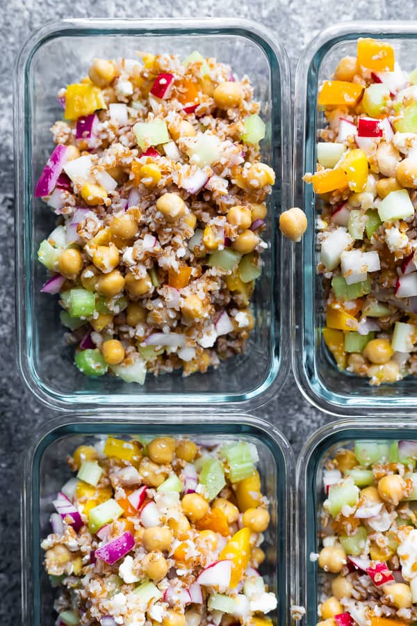 overhead shot of four glass meal prep container with chopped chickpea salad