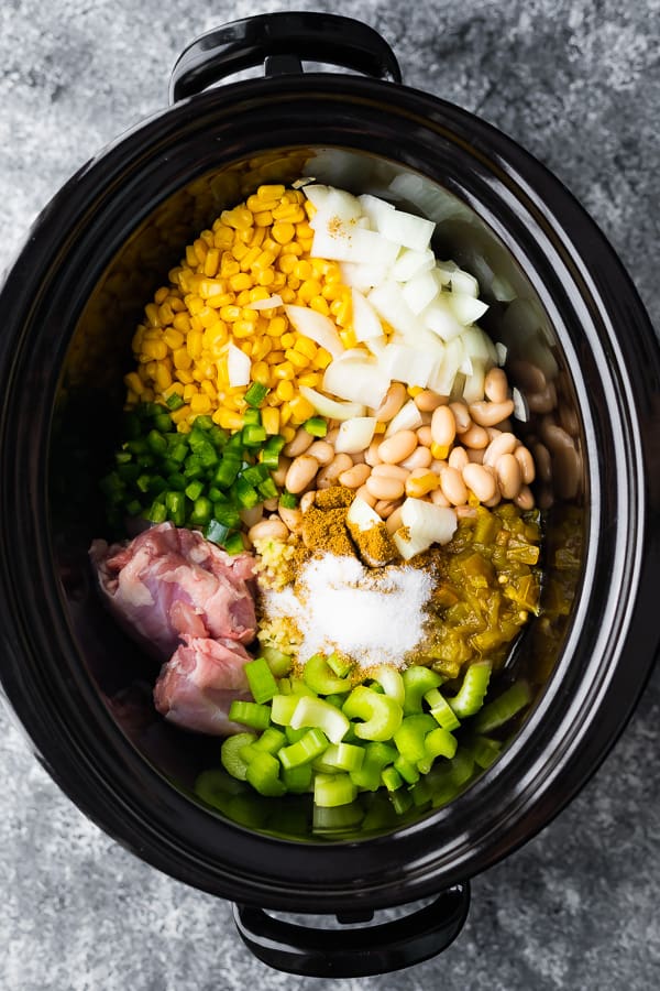 ingredients for white bean chicken chili crock pot recipe in the slow cooker before cooking