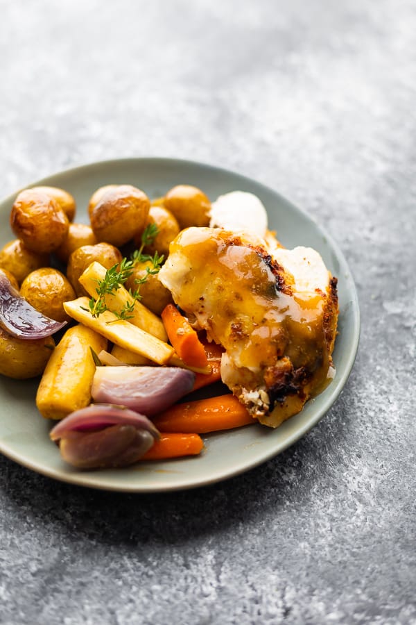 slow cooker whole chicken with vegetables and potatoes on a plate