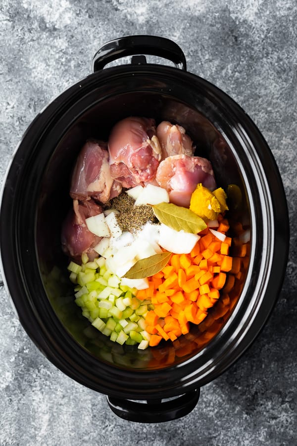 ingredients for slow cooker chicken noodle soup in the slow cooker before cooking