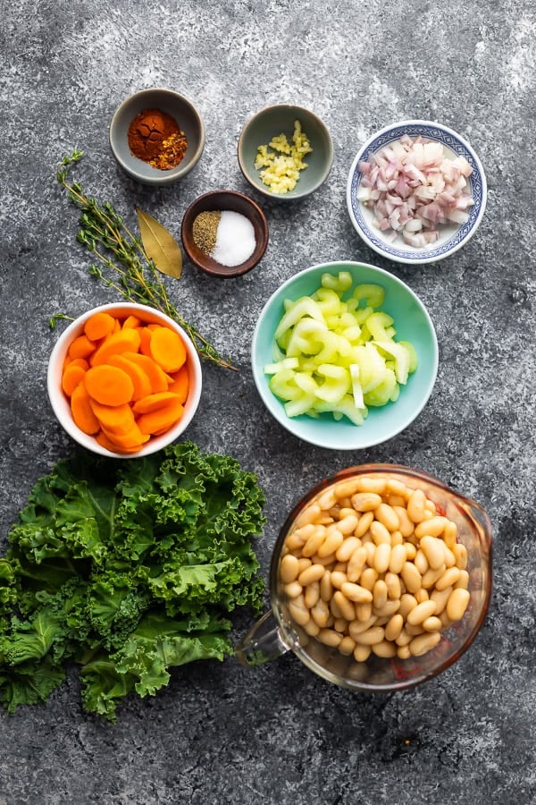 overhead view of ingredients required for white bean kale soup