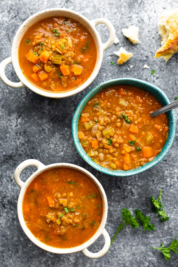 overhead view of three bowls of lentil vegetable soup