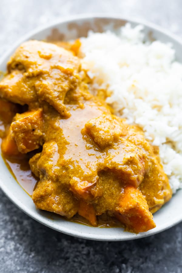 close up view of Slow Cooker Chicken Korma in a bowl with rice