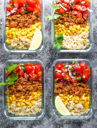 overhead shot of four containers filled with turkey taco meal prep bowls