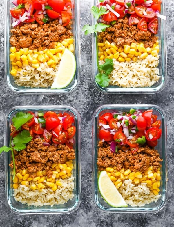 overhead shot of four containers filled with turkey taco meal prep bowls