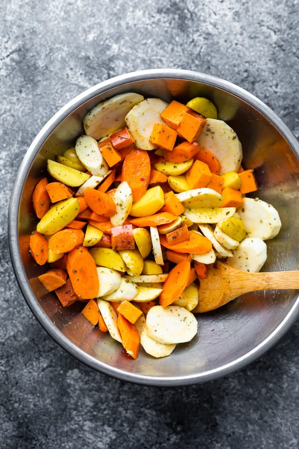 prepping the vegetables in a bowl for the oven roasted pork tenderloin