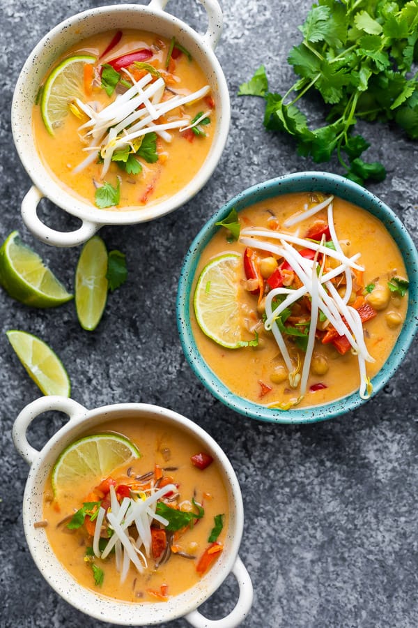 overhead view of three bowls of thai coconut curry soup