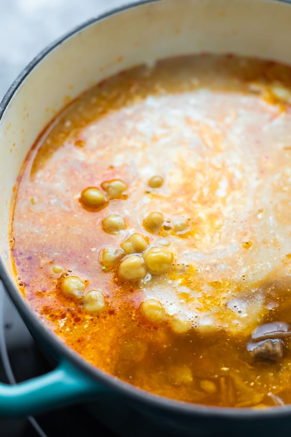 close up of curry soup recipe after adding coconut milk