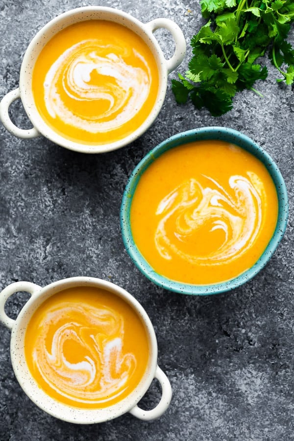 three bowls with thai butternut squash soup