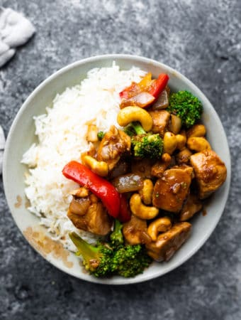 overhead shot of gray bowl filled with maple ginger cashew chicken stir fry