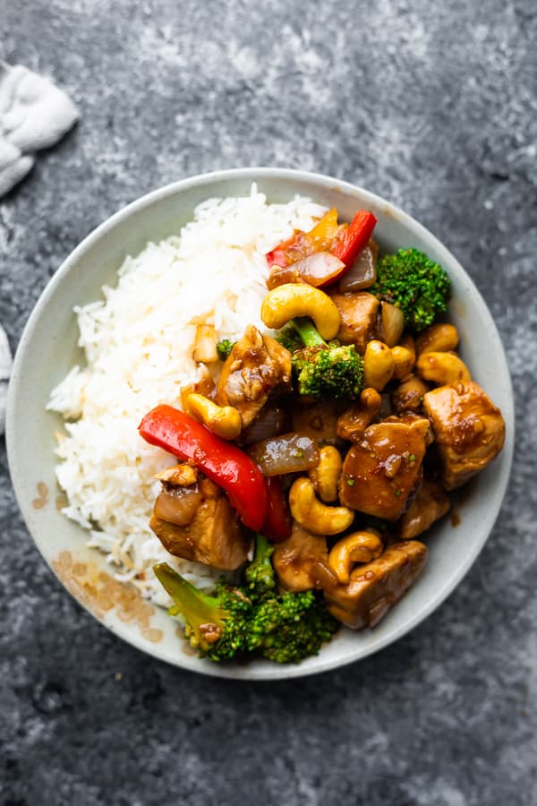cashew chicken stir fry in a bowl with rice