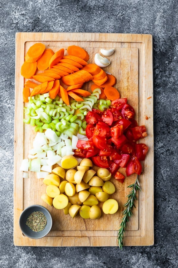 ingredients for slow cooker chicken stew on cutting board