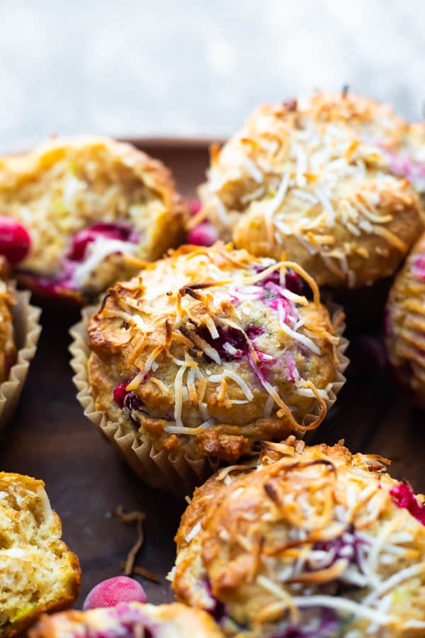 close up shot of coconut cranberry muffins on brown plate