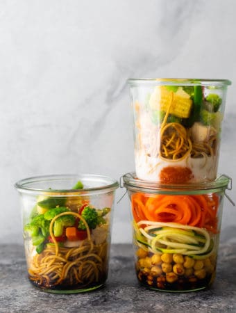 three jars with homemade instant noodles on gray background