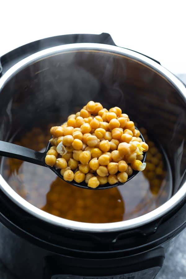 scooping instant pot chickpeas with a spoon