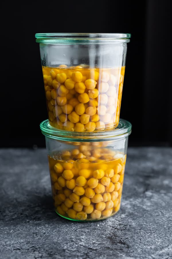 two mason jars with cooked chickpeas + chickpea cooking liquid to be frozen