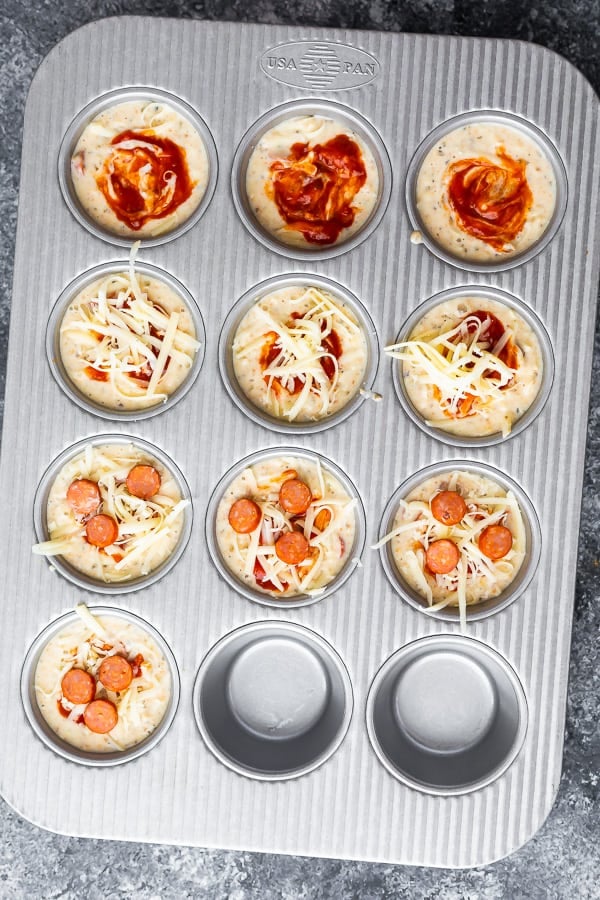 pizza puffs in muffin tin before baking