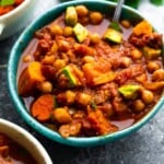 spicy slowcooker chickpea chili in a blue bowl with a spoon