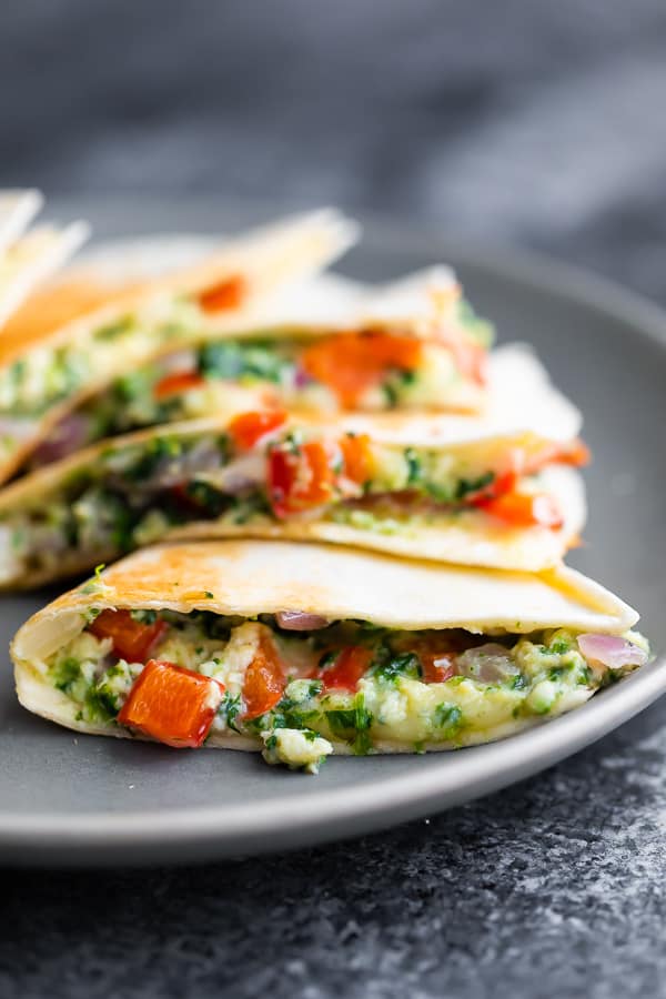 close up side angle of the spinach feta breakfast quesadillas showing the gooey filling