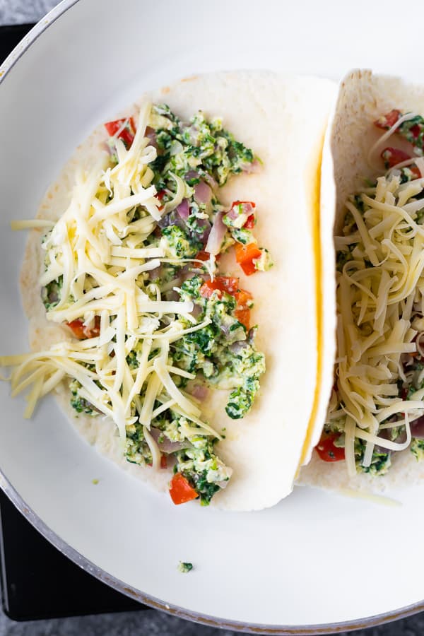 showing how to make a breakfast quesadilla in frying pan