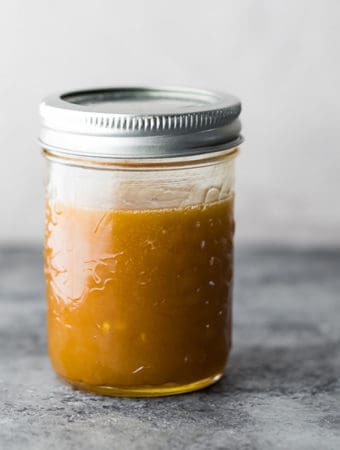 5 minute asian salad dressing in a mason jar on gray background