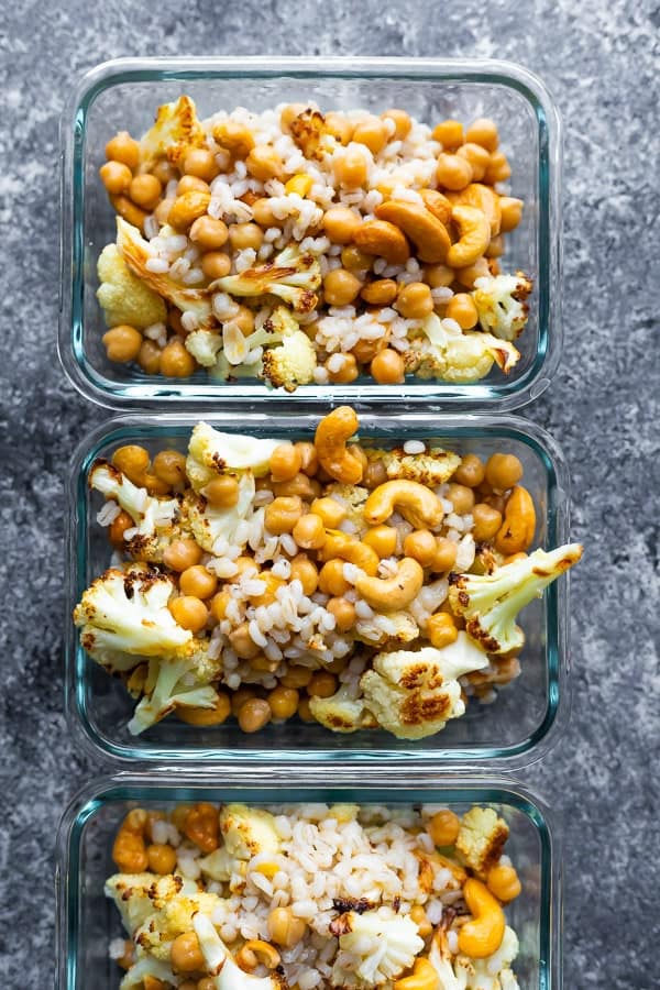 overhead view of 4 Cashew Cauliflower Lunch Bowls in meal prep containers