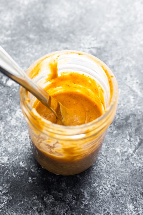 peanut sauce in mason jar with a spoon