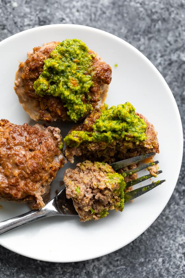 plate of Moroccan spiced mini meatloaf cups with mint pistachio pesto on top