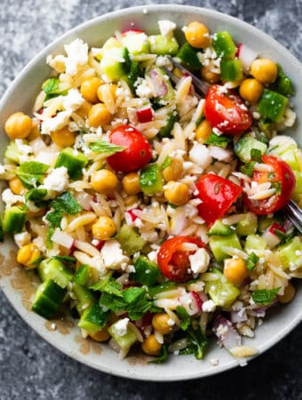 Orzo pasta salad with mint and feta in white bowl