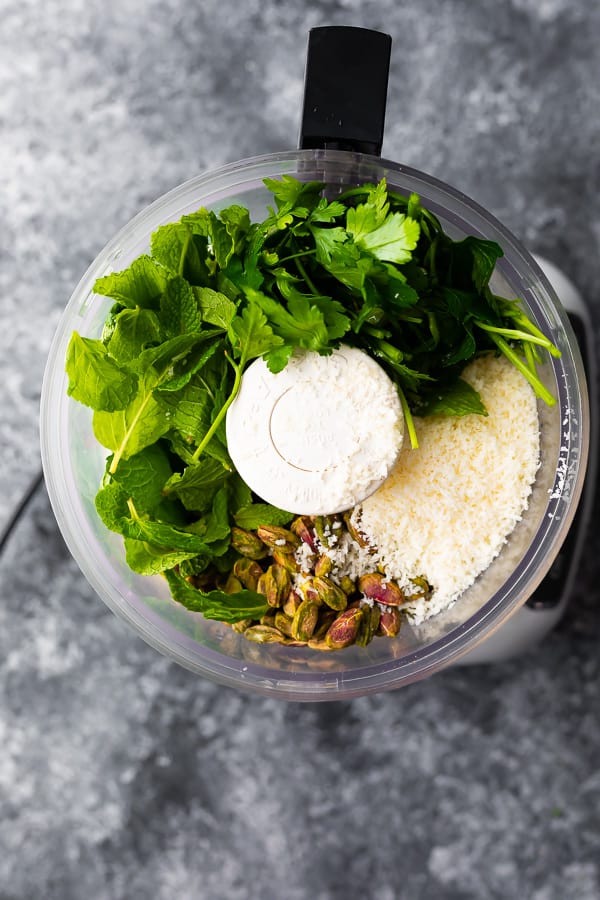 making pesto in bowl of food processor