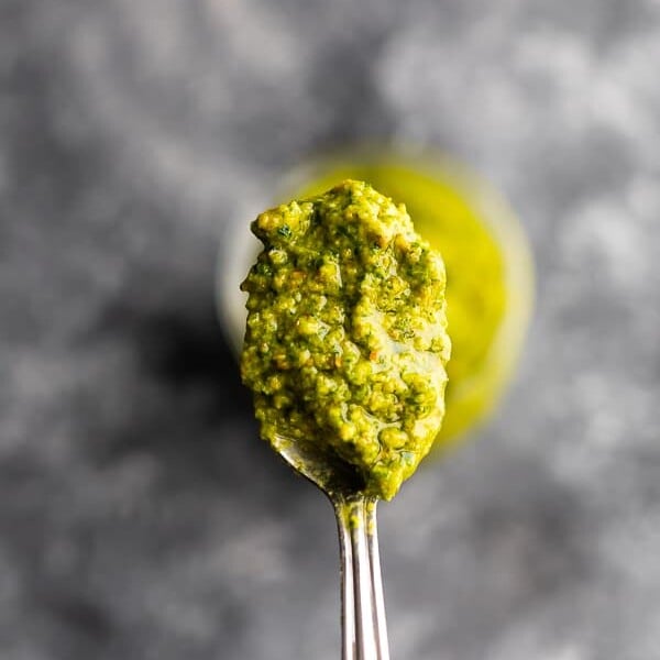 Close up shot of mint and pistachio pesto on a spoon