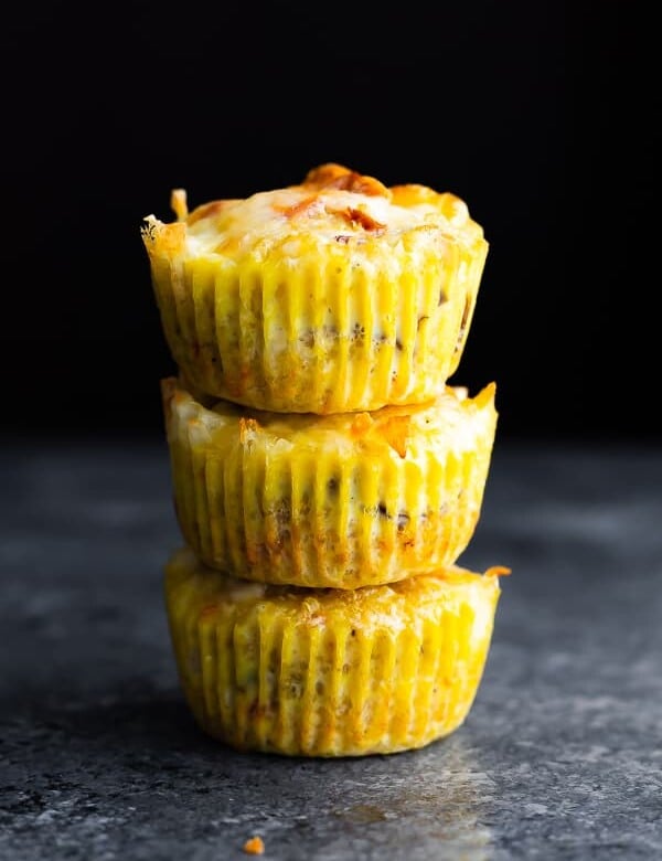 stack of three quinoa egg muffins on gray background
