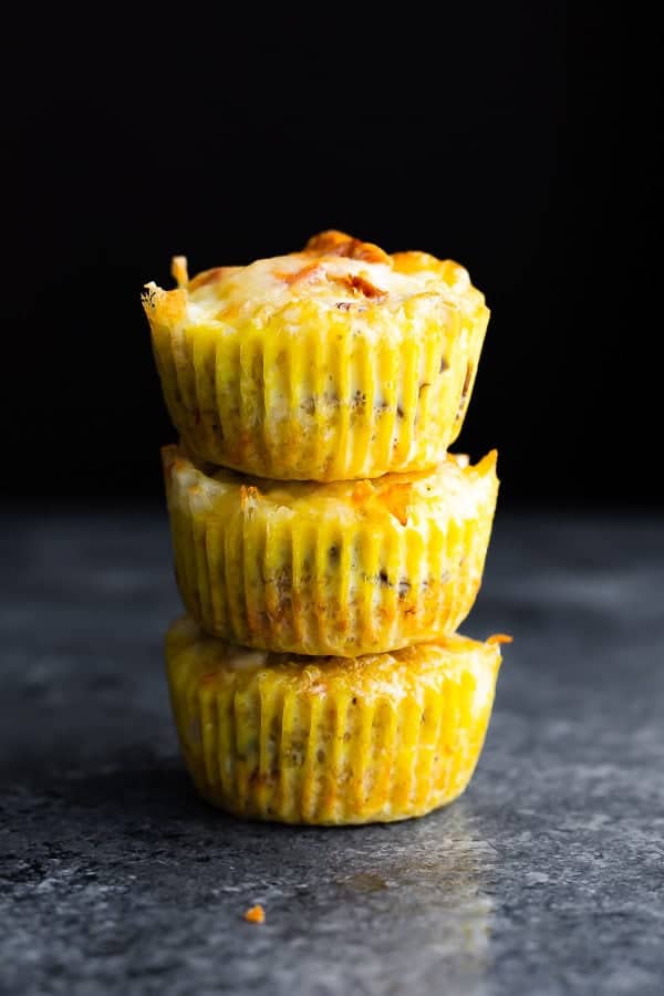 stack of three quinoa egg muffins on gray background