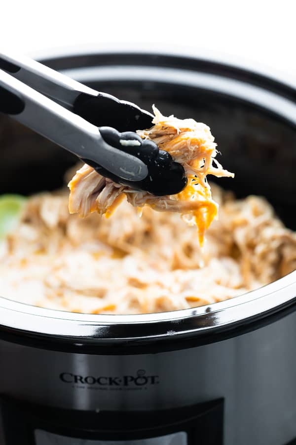 tongs picking up Slow Cooker Honey Lime Chicken