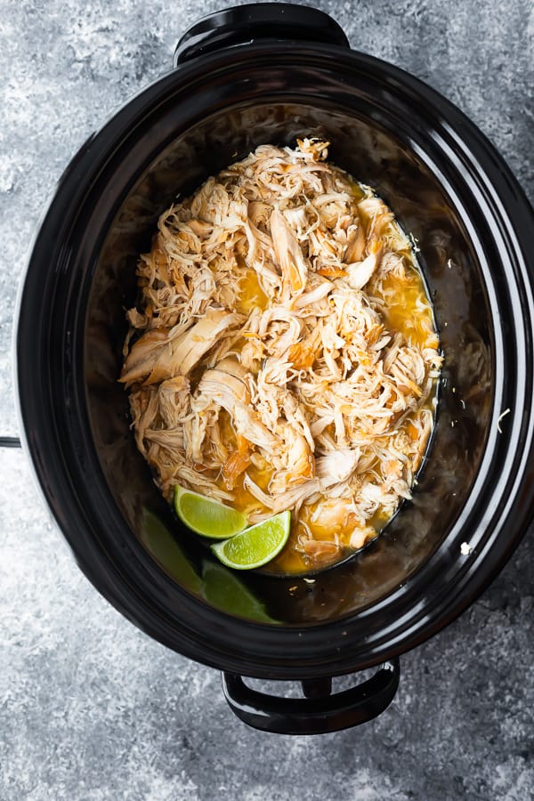 slow cooker containing shredded chicken