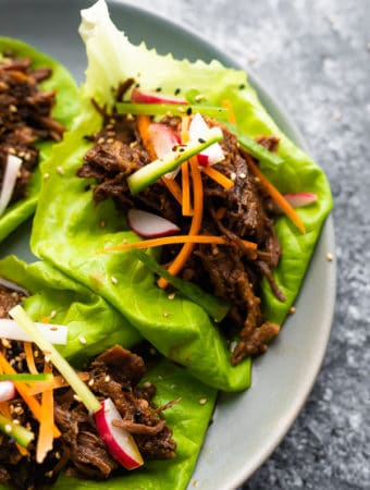 Korean beef lettuce wraps on a gray plate