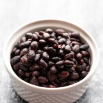 a white bowl filled with black beans