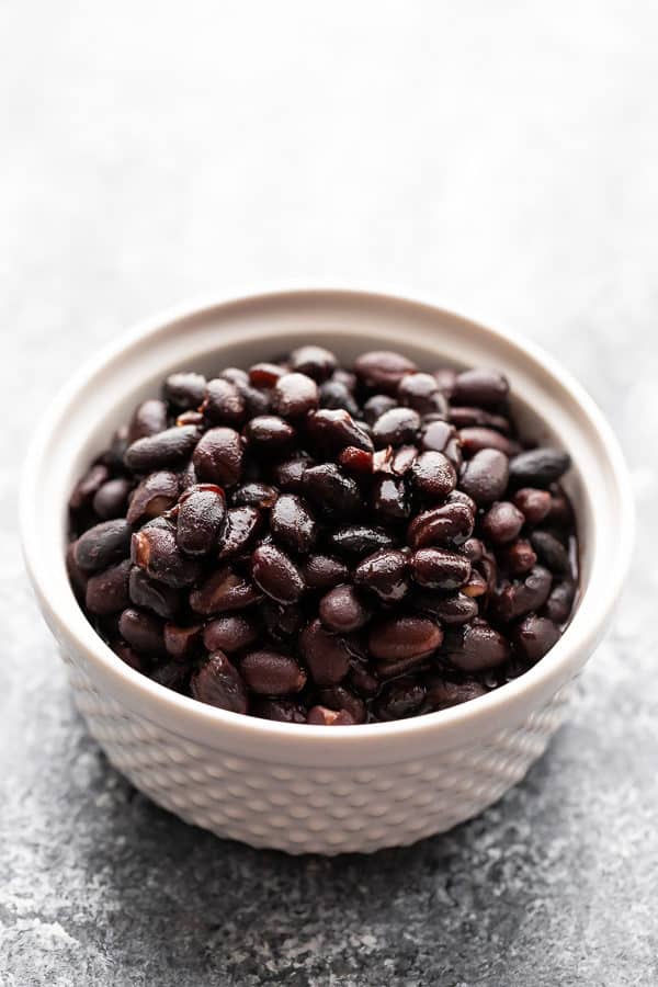 a white bowl filled with black beans