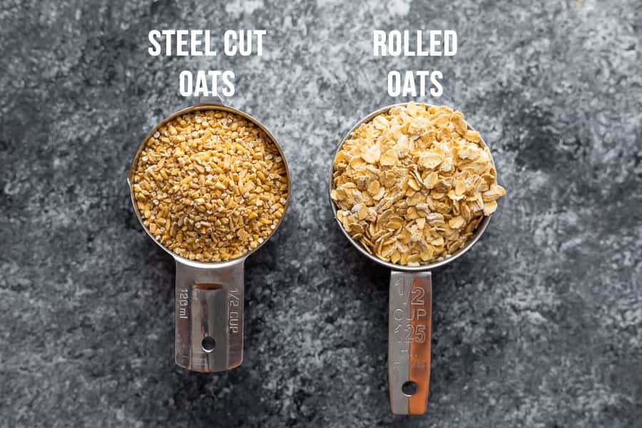 measuring cups with rolled oats and steel cut oats side by side