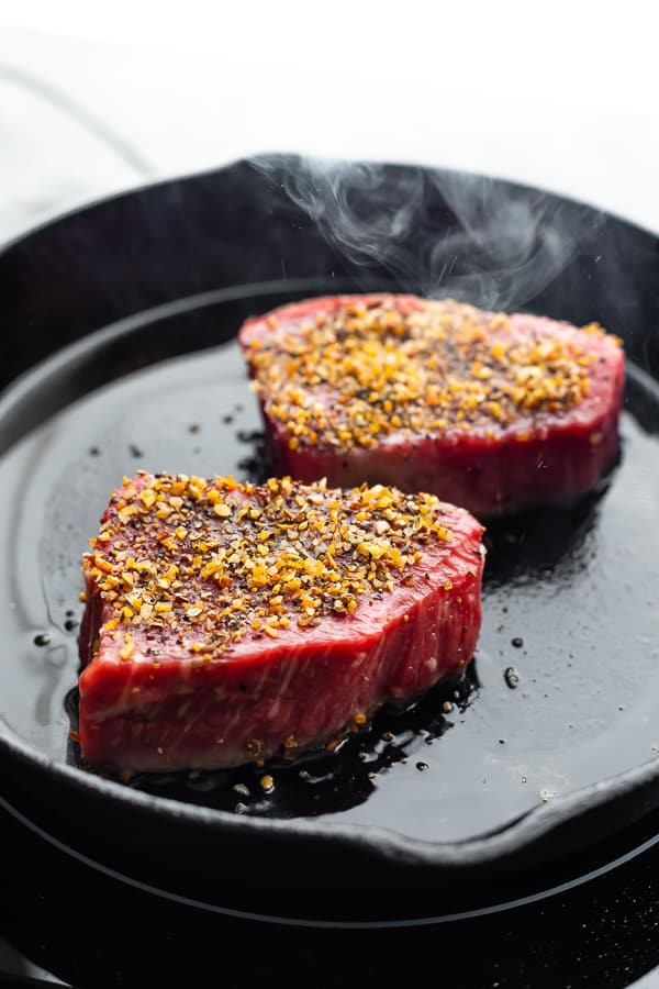 cooking steaks in a cast iron pan