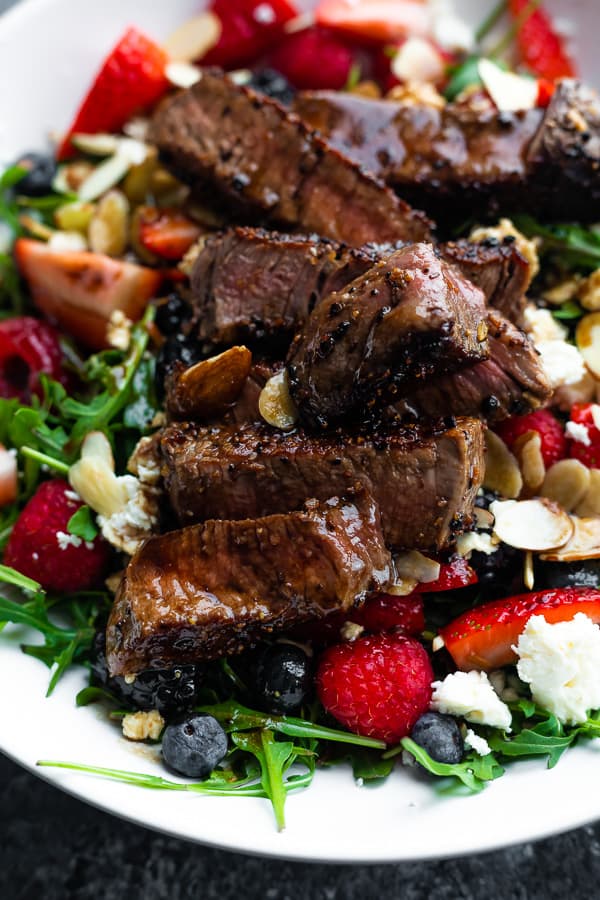 close up shot of arugula steak salad