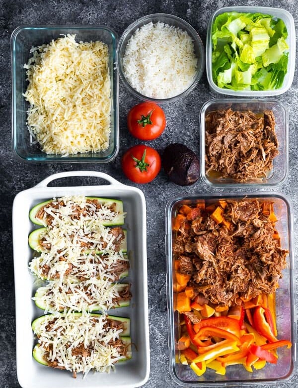 overhead shot of multiple meal prep containers and fresh produce for pulled pork meal prep plan