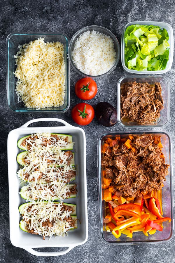 overhead shot of multiple meal prep containers and fresh produce for pulled pork meal prep plan