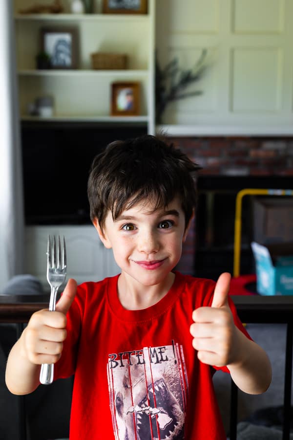 kai holding a fork giving thumbs up sign 