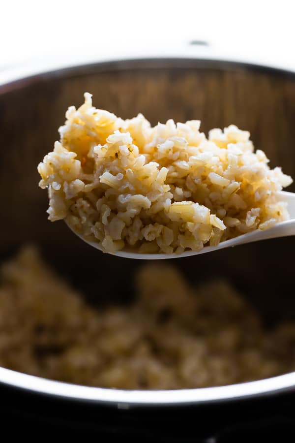 brown basmati rice on a spoon over the Instant Pot